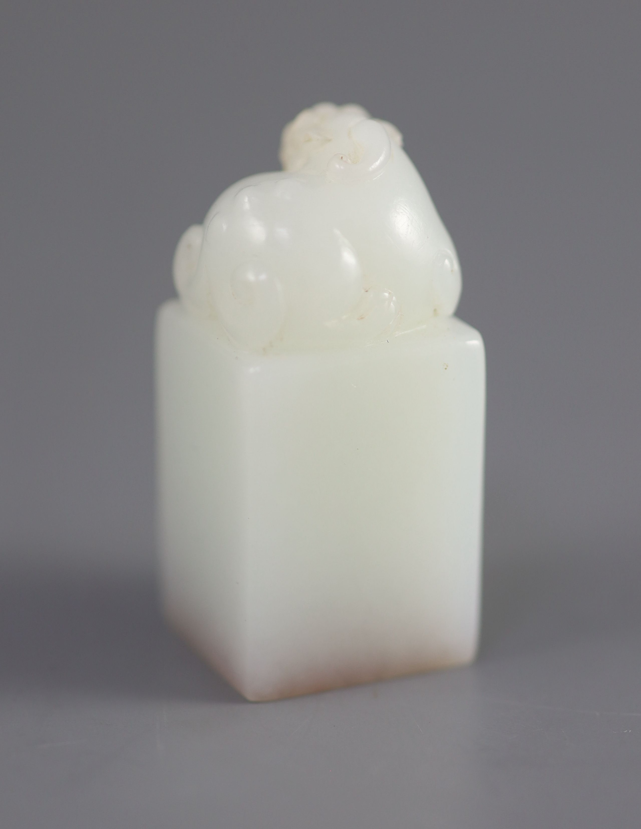 A Chinese inscribed white jade seal, 20th century, 4.3cm